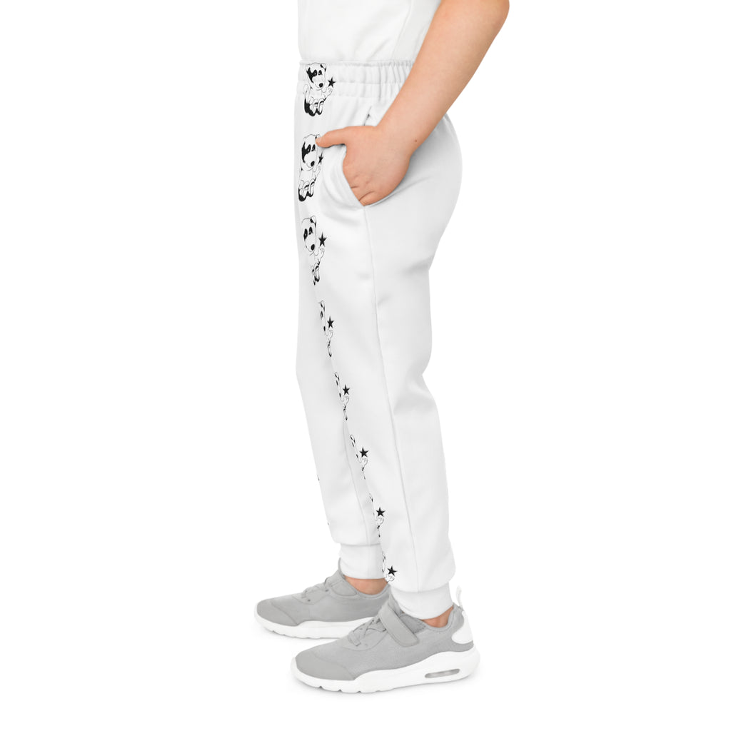 Left side-view of a boy wearing white sweatpants with a line of black and white foxes down the front left leg.