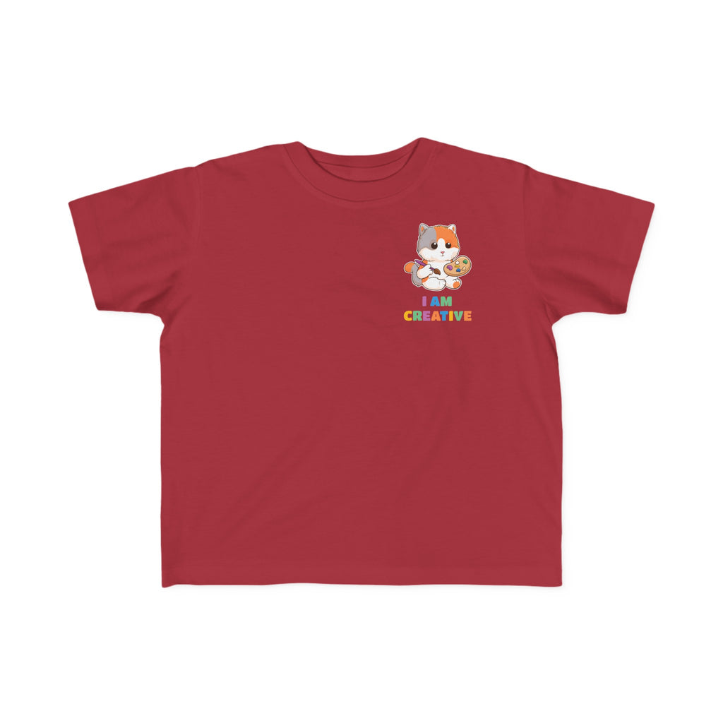 A short-sleeve garnet red shirt with a small picture on the left chest. The image is a cat with a multi-color phrase below it that says I am creative.