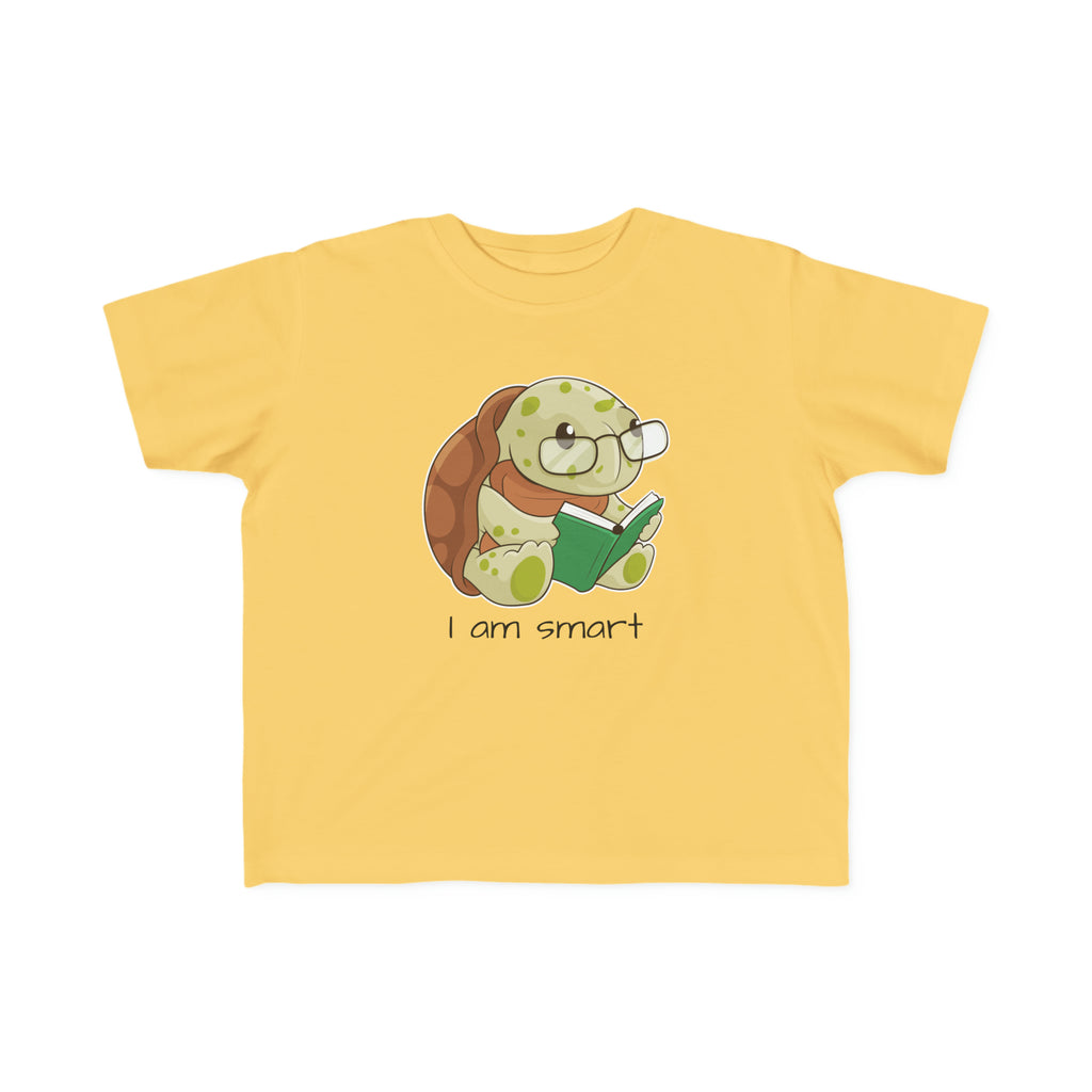 A short-sleeve yellow shirt with a picture of a turtle that says I am smart.