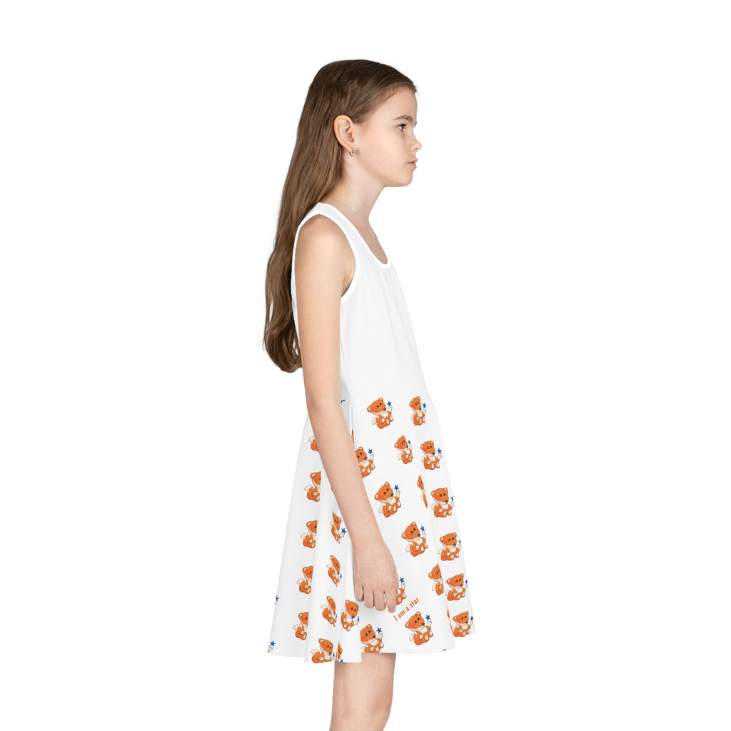 Right side-view of a girl wearing a sleeveless white dress with a white top and a repeating pattern of a fox on the skirt.