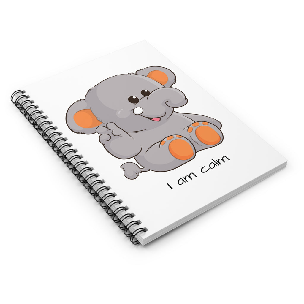 Side-view of a white spiral notebook laying closed, featuring a picture of an elephant that says I am calm.