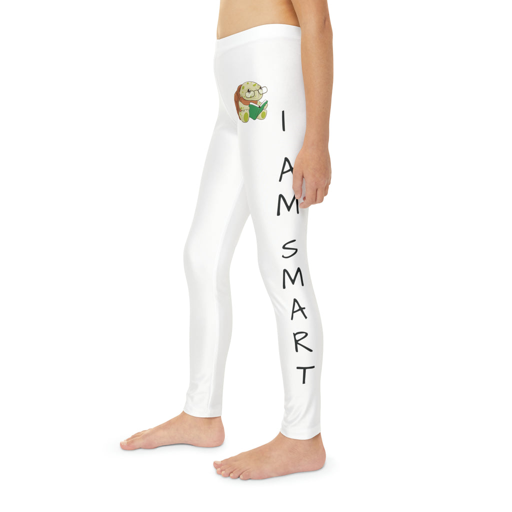 Left side-view of a child wearing white leggings with a picture of a turtle on the front left waist and the phrase "I am smart" read top to bottom on the side of each leg.
