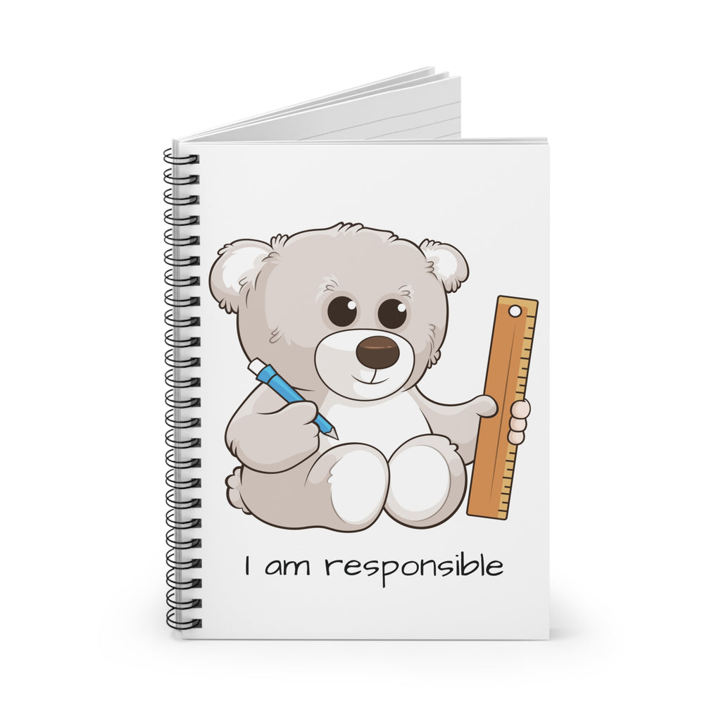 White spiral notebook standing up, featuring a picture of a bear that says I am responsible on the front.