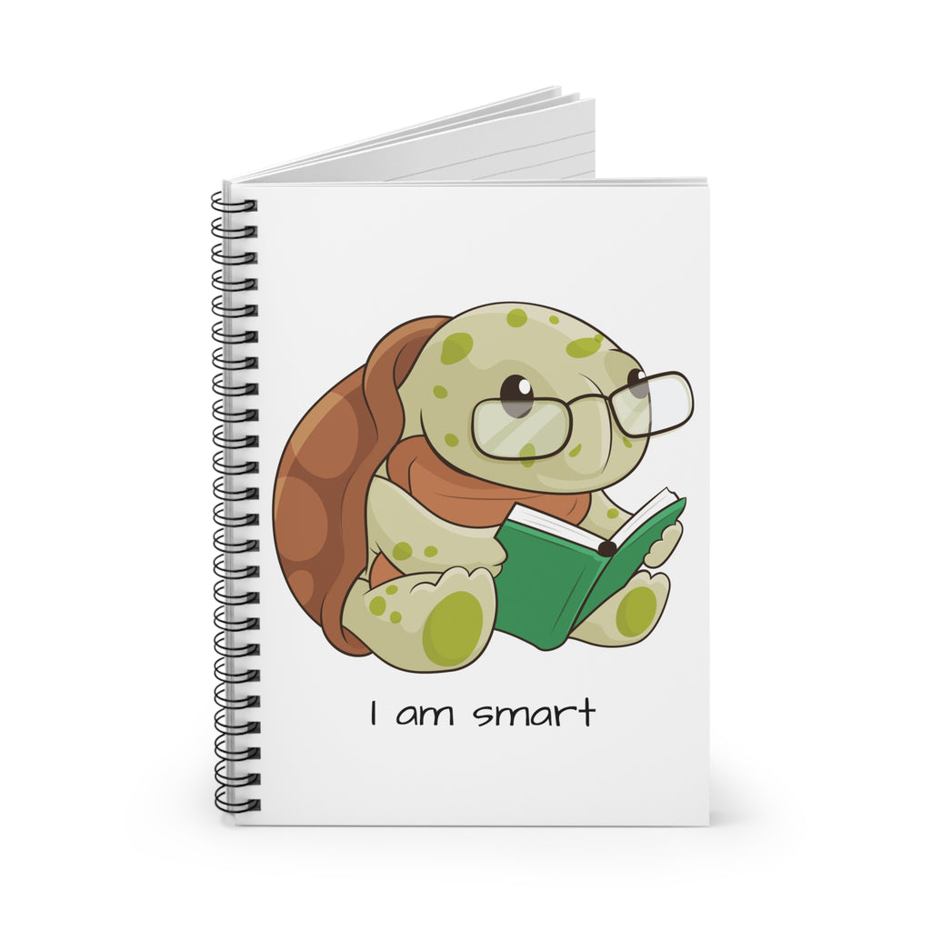 White spiral notebook standing up, featuring a picture of a turtle that says I am smart on the front.