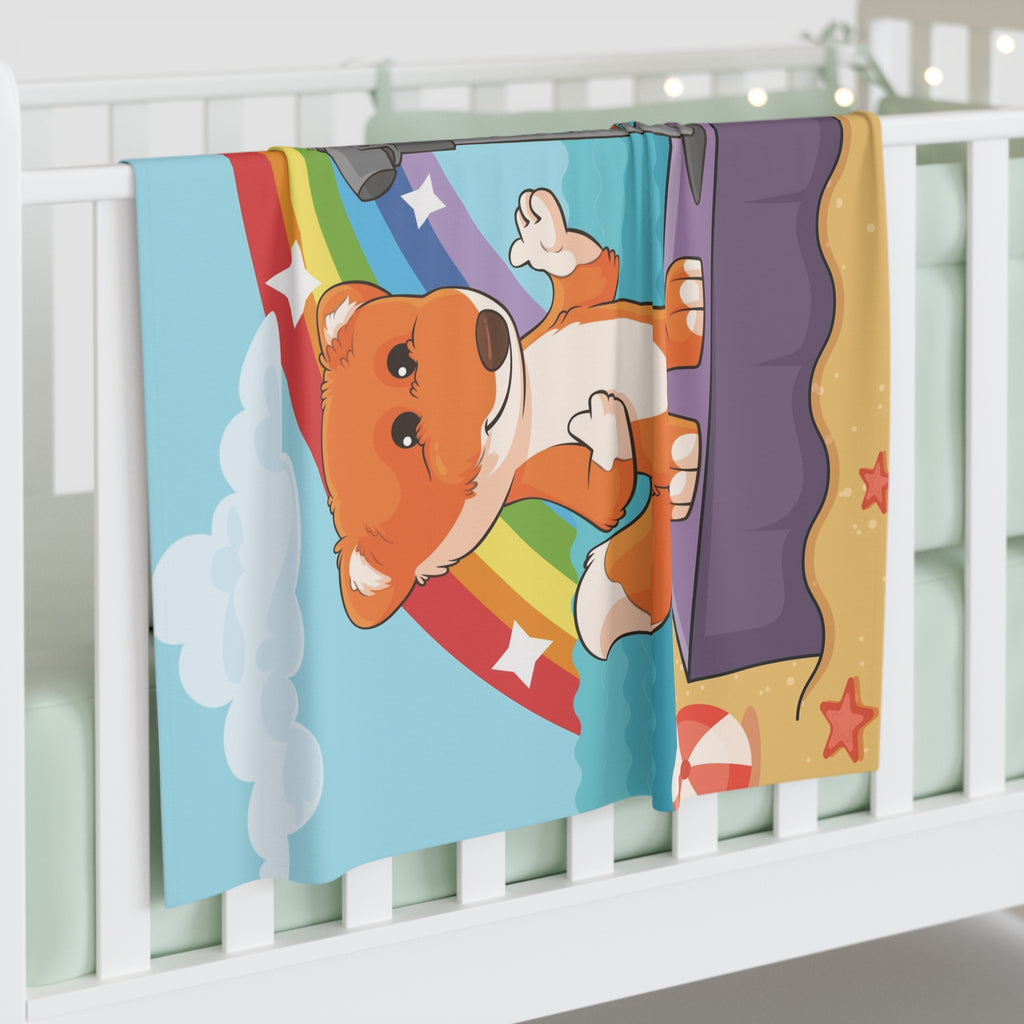 Full-color swaddle blanket with a scene of a fox singing with a bird and squirrel on a stage on the beach with a rainbow in the background. The blanket is draped over the side of a baby crib.