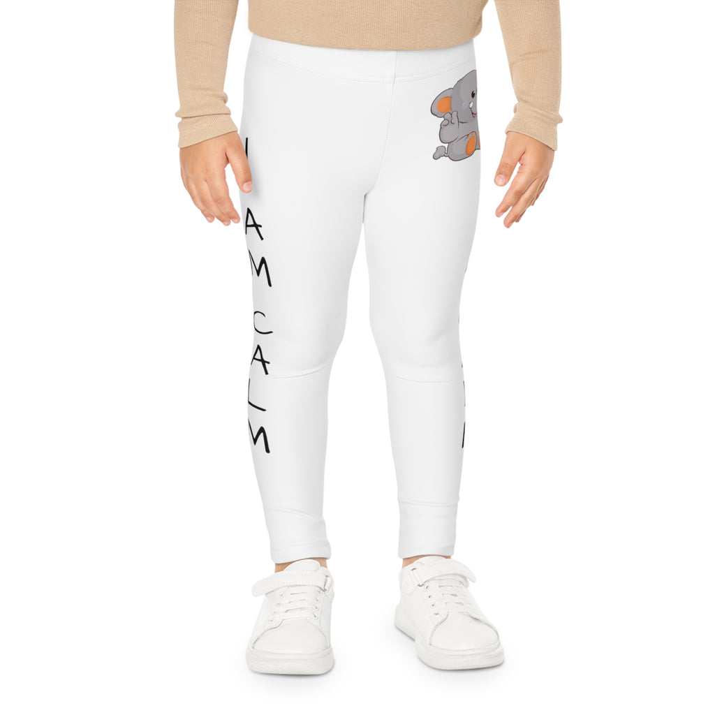 Front-view of a child wearing white leggings with a picture of an elephant on the front left waist and the phrase "I am calm" read top to bottom on the side of each leg.