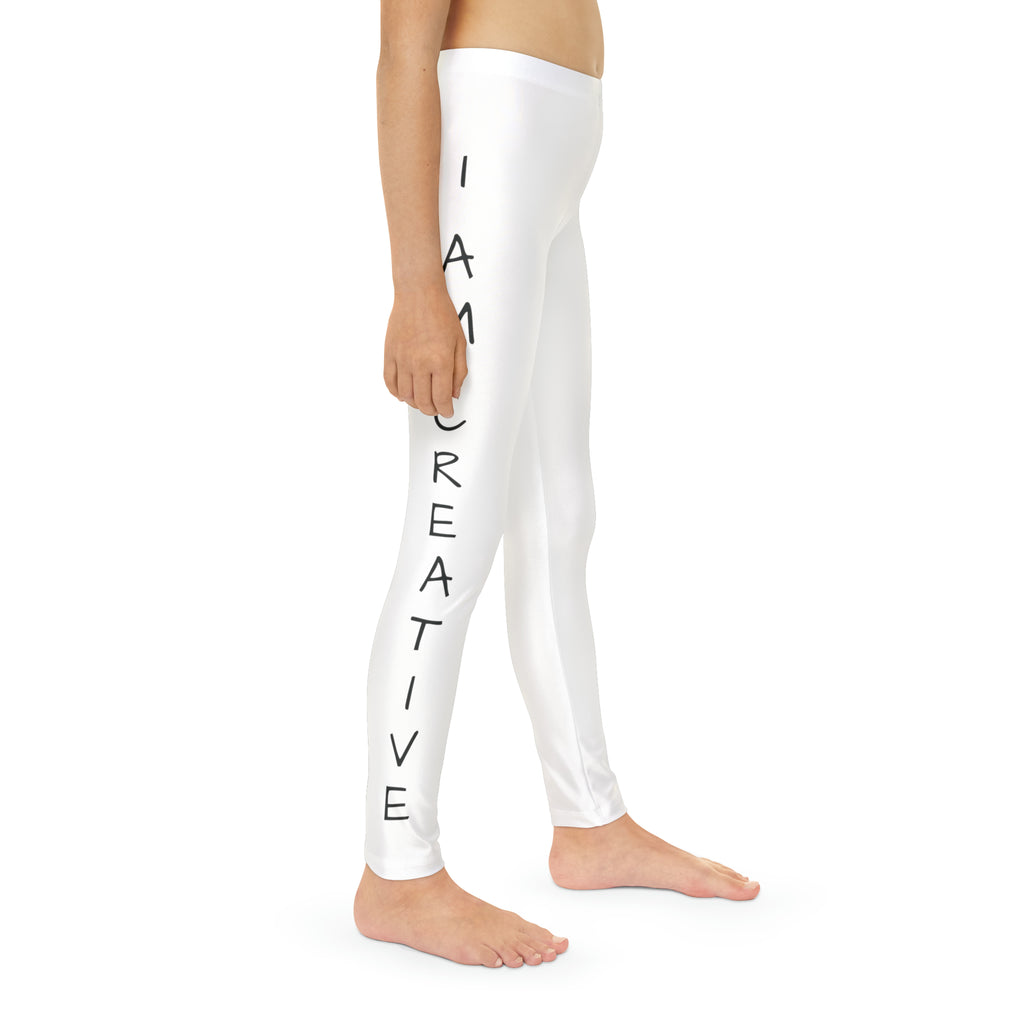 Right side-view of a child wearing white leggings with a picture of a cat on the front left waist and the phrase "I am creative" read top to bottom on the side of each leg.
