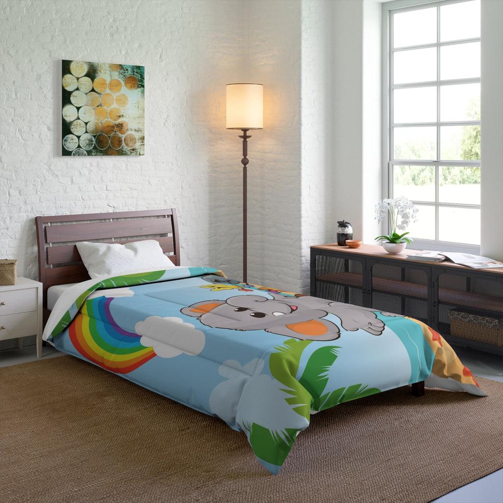 A 68 by 92 inch bed comforter with a scene of an elephant having a bonfire with a bird and fish on the beach, a rainbow in the background, and the phrase "I am calm" along the bottom. The comforter covers a twin extra long sized bed.