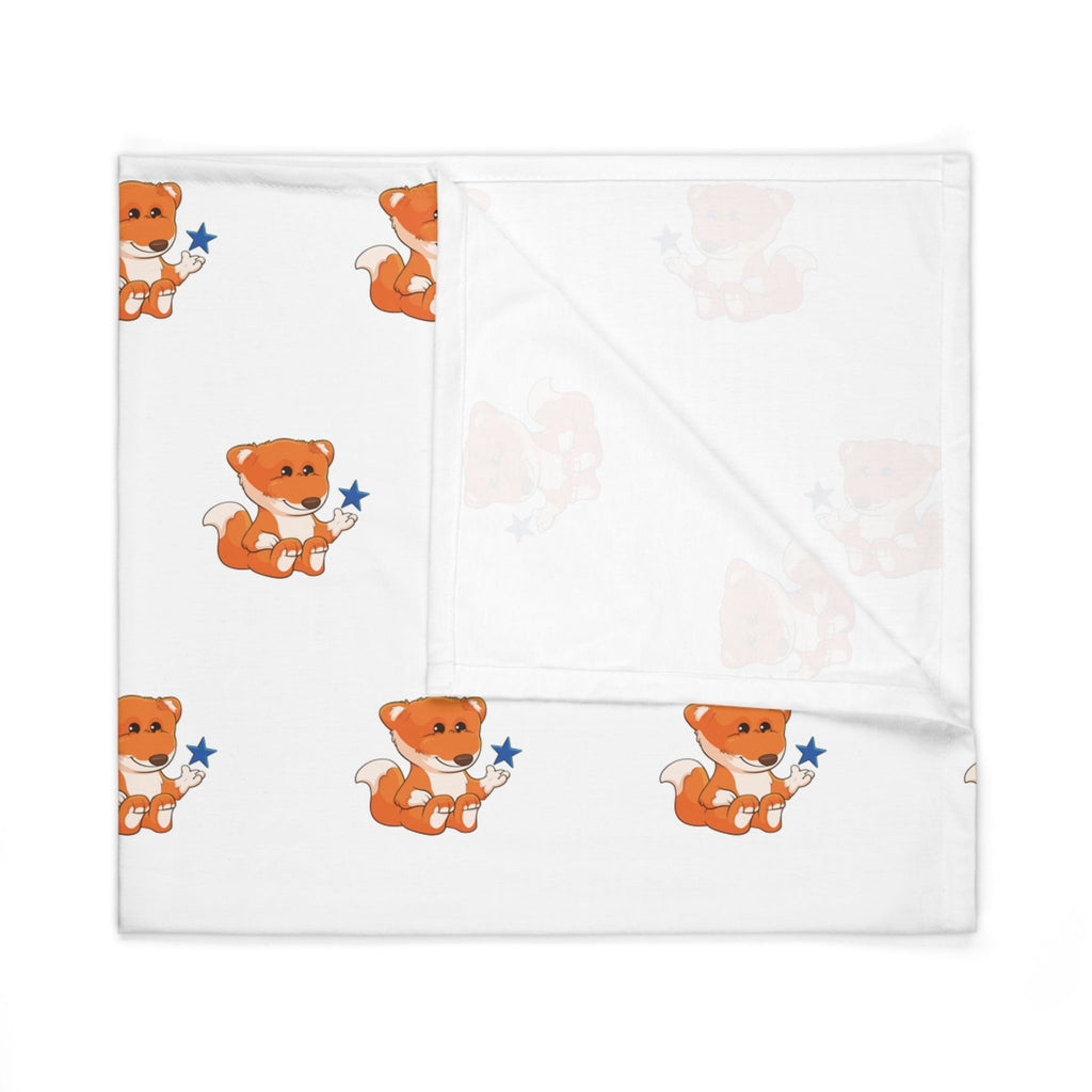 A white swaddle blanket with a repeating pattern of a fox. The blanket is folded into a square.