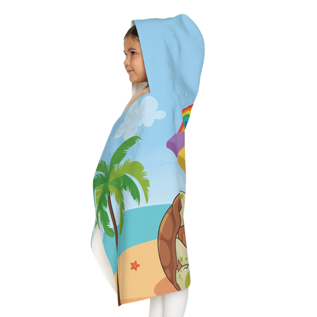 Left side-view of a girl wearing a hooded towel and holding it closed around her. The towel has a scene of a turtle reading a book under an umbrella on the beach, a rainbow in the background, and the phrase "I am smart" along the bottom.