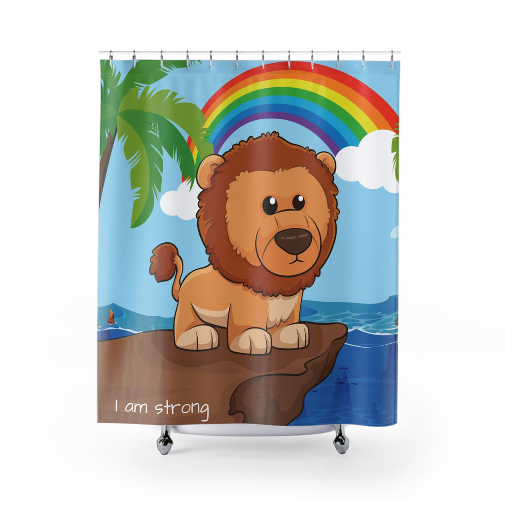 A shower curtain hanging from a rod in front of a stand-alone tub. The shower curtain has a scene of a lion standing on a cliff over the ocean with a rainbow in the background and the phrase "I am strong" along the bottom.