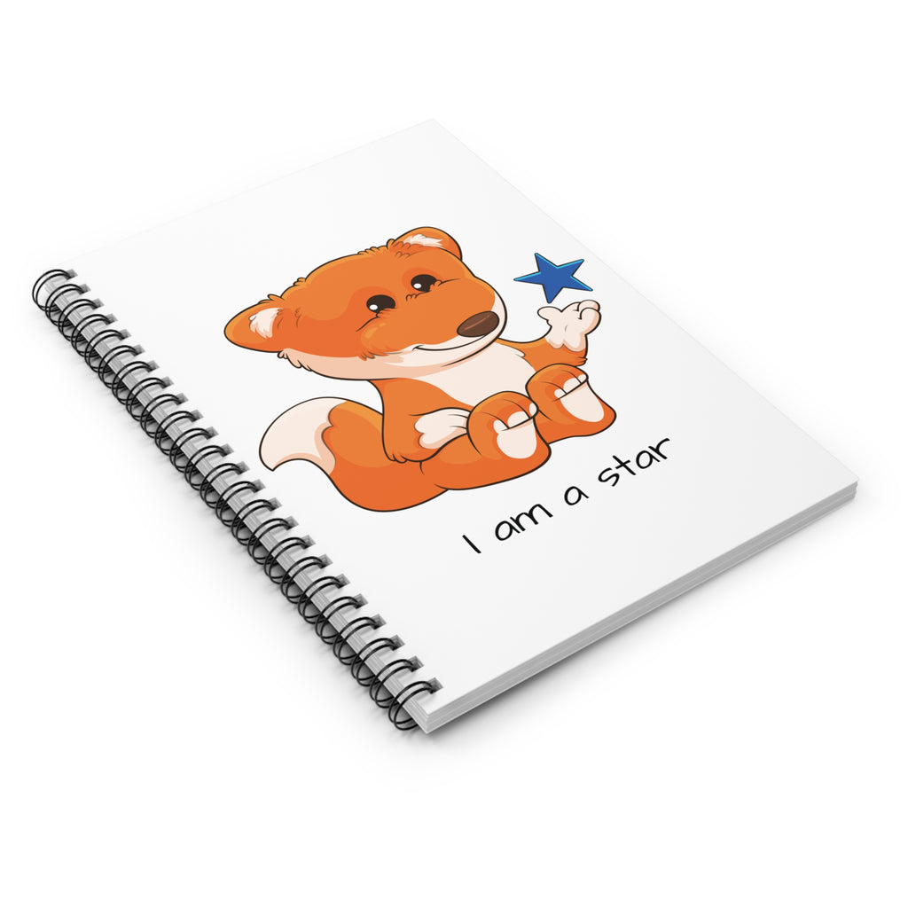 Side-view of a white spiral notebook laying closed, featuring a picture of a fox that says I am a star.