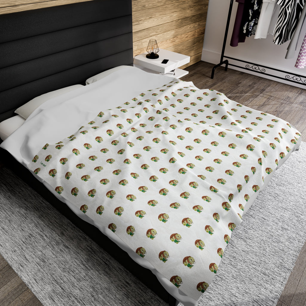 A 60 by 80 inch blanket on a queen-sized bed in a bedroom. The blanket has a repeating pattern of a turtle and the phrase “I am smart” in the bottom left corner.