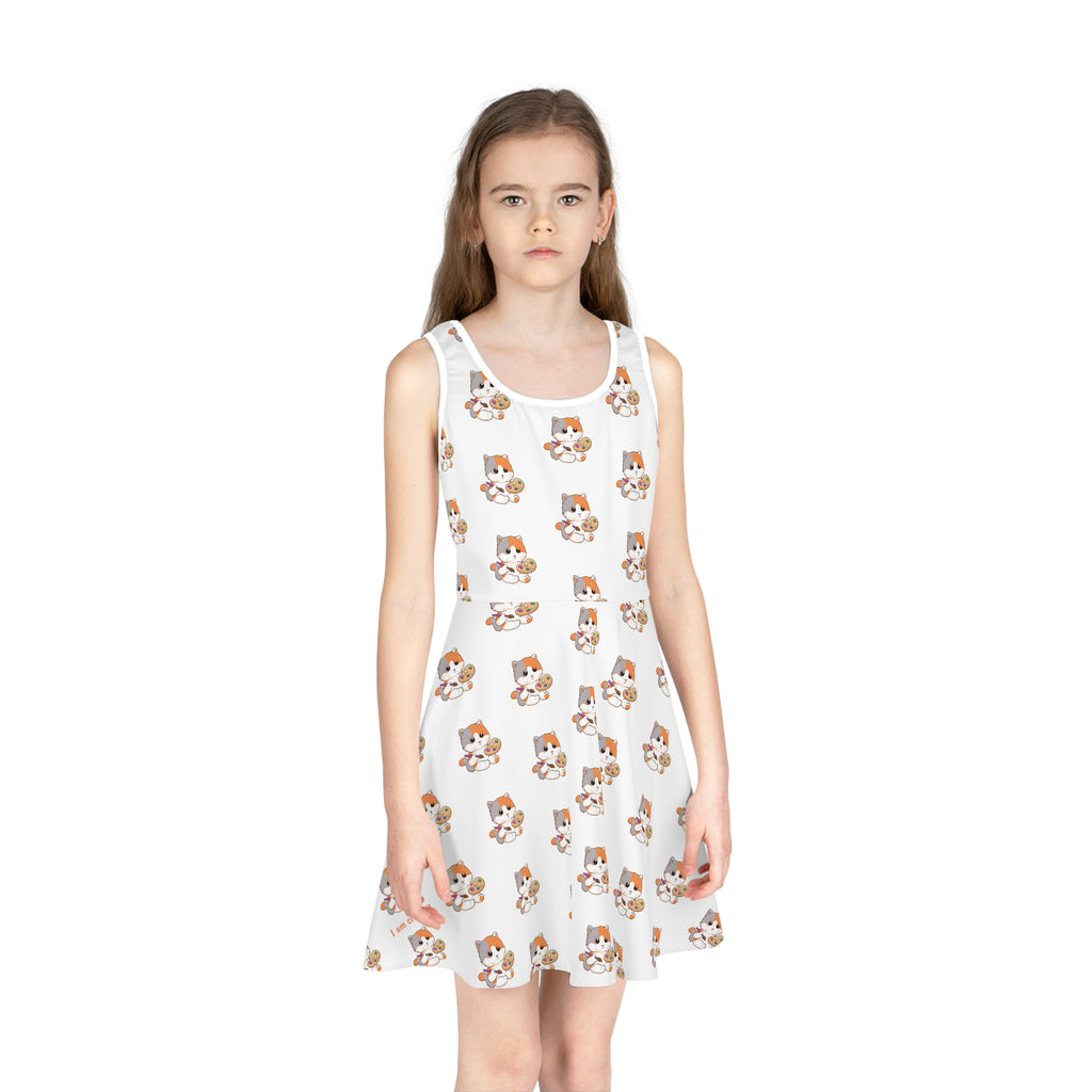 Front-view of a girl wearing a sleeveless white dress with a repeating pattern of a cat.