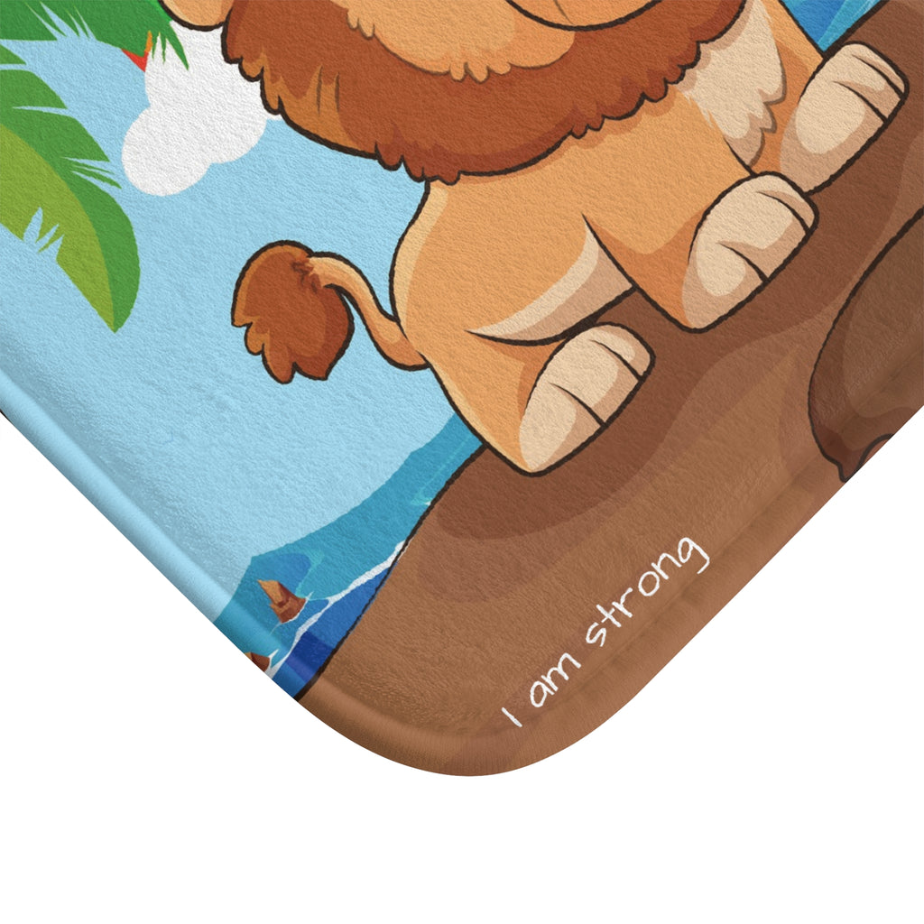 A close-up of a corner of the bath mat with a scene of a lion standing on a cliff over the ocean.