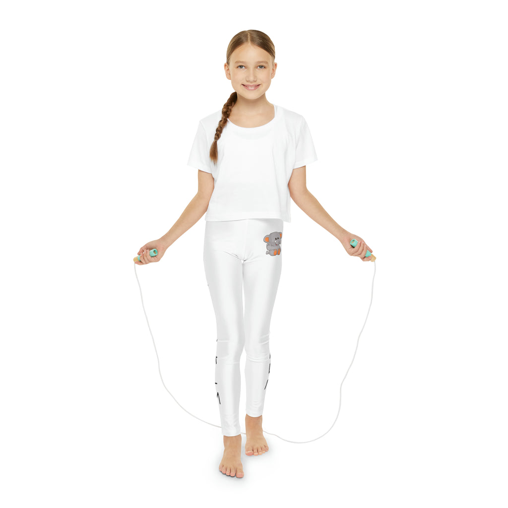 A girl using a jump rope while wearing white leggings with a picture of an elephant on the front left waist and the phrase "I am calm" read top to bottom on the side of each leg.
