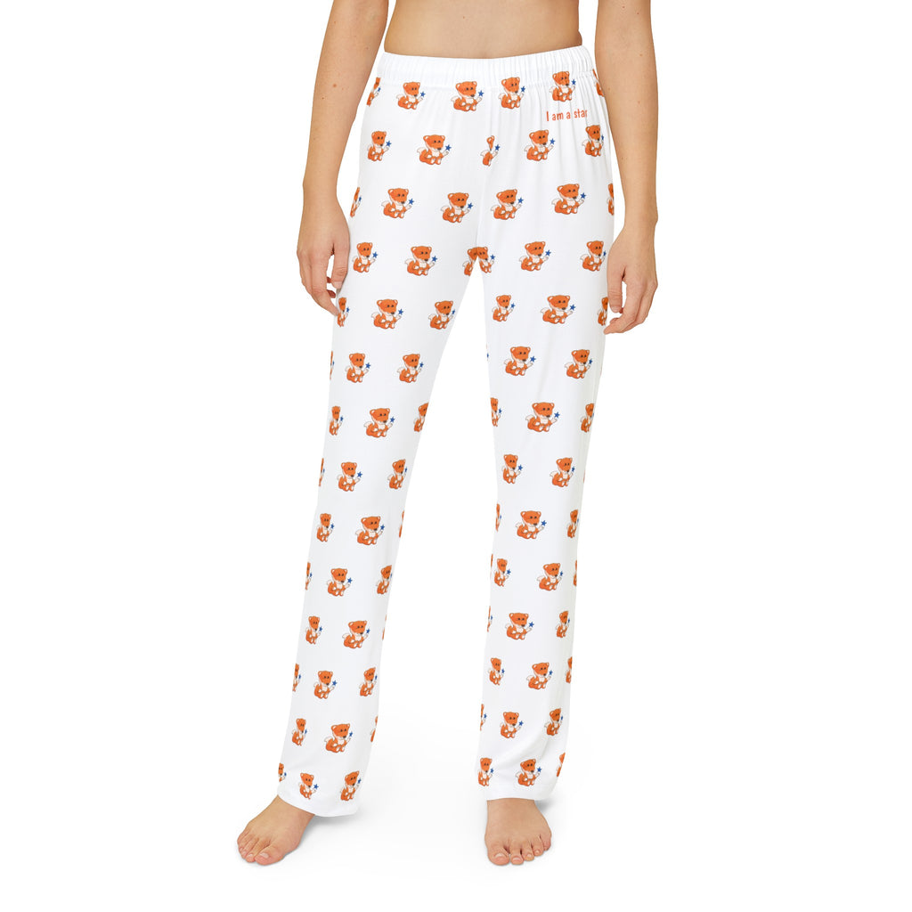 Front-view of a kid wearing white pajama pants with a repeated pattern of a fox and the phrase “I am a star” on the front left waist.