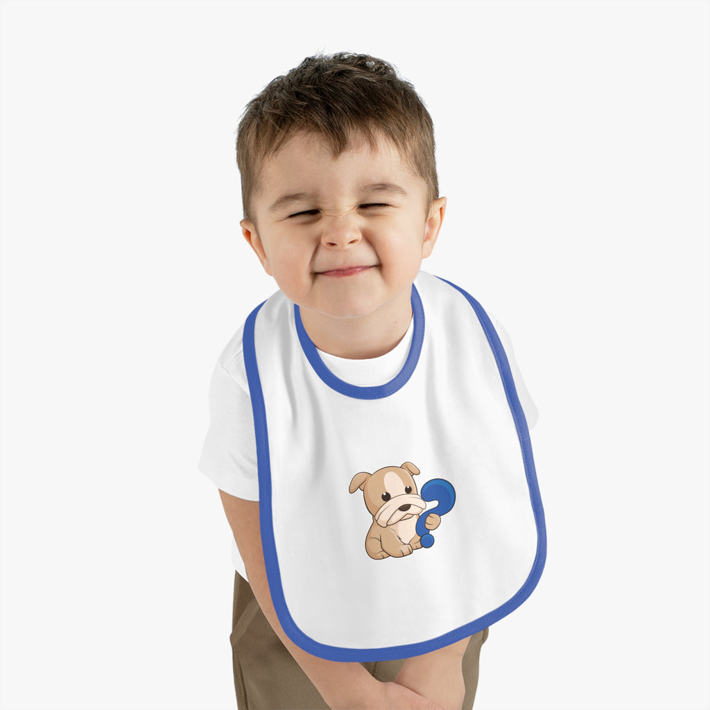 A little boy wearing a white baby bib with royal blue trim and a small picture of a dog.