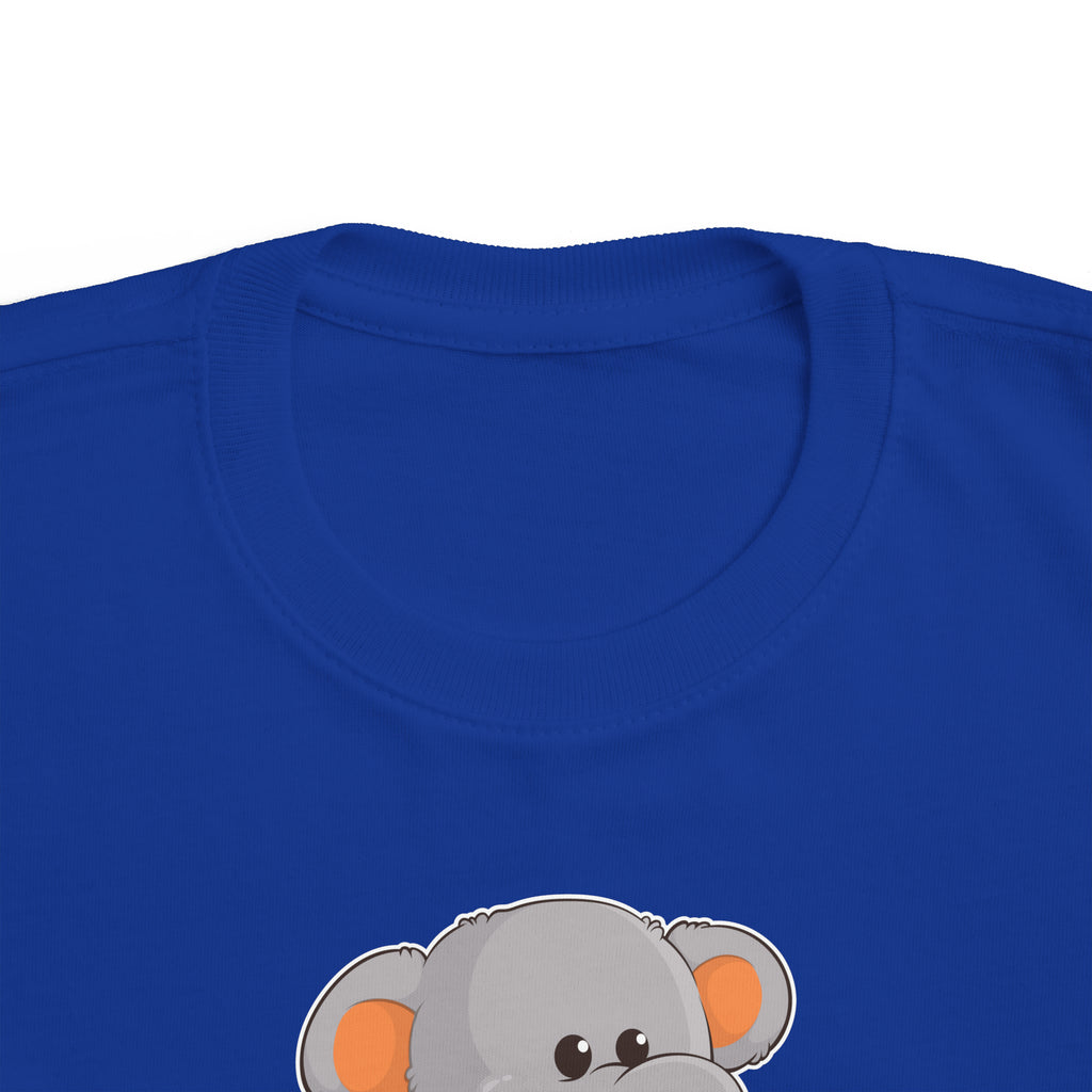 A close-up of the crew neckline of a short-sleeve royal blue shirt with a picture of an elephant that says I am calm.