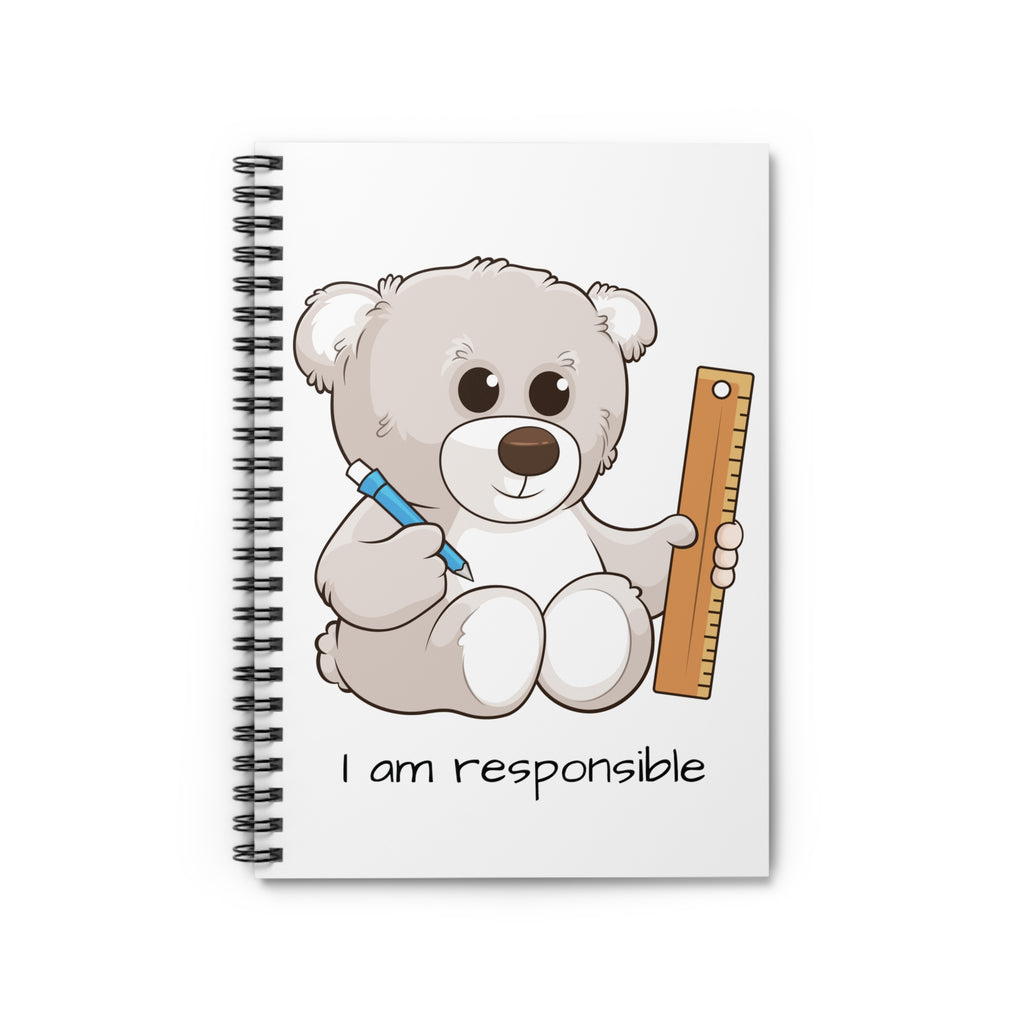 White spiral notebook laying closed, featuring a picture of a bear that says I am responsible.