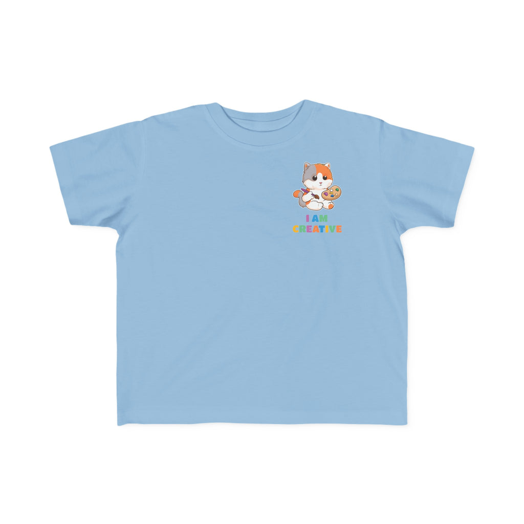 A short-sleeve light blue shirt with a small picture on the left chest. The image is a cat with a multi-color phrase below it that says I am creative.