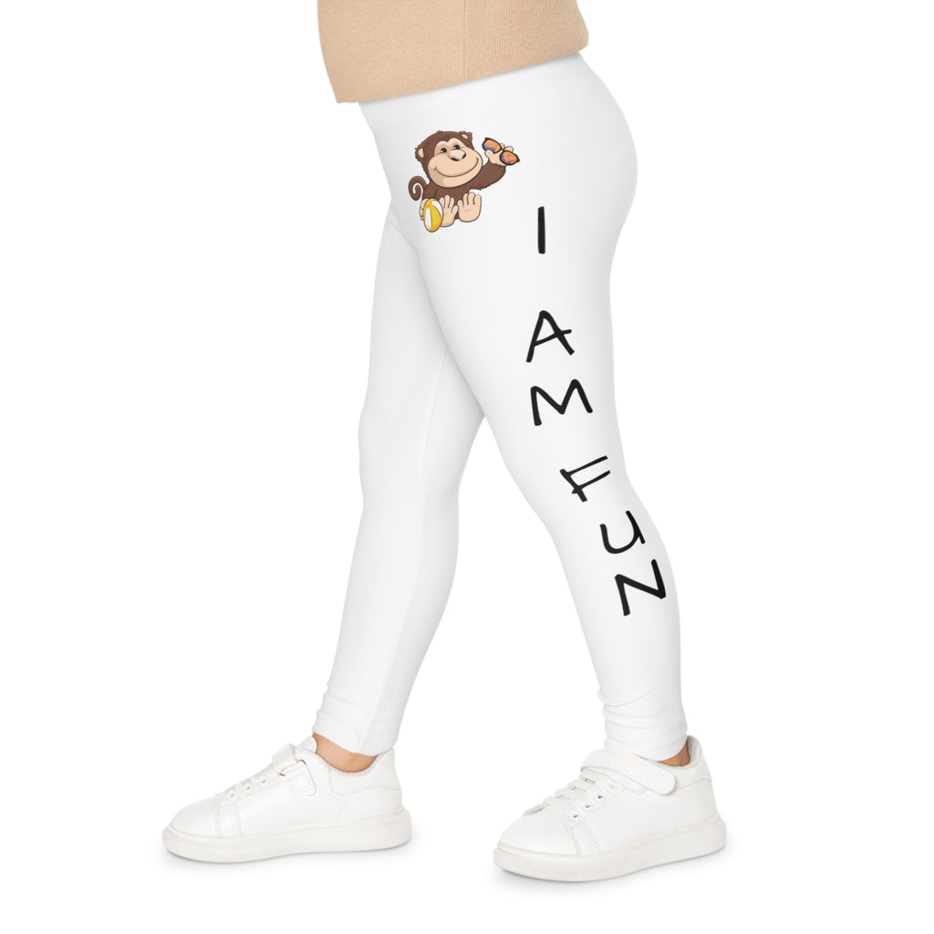 Left side-view of a child wearing white leggings with a picture of a monkey on the front left waist and the phrase "I am fun" read top to bottom on the side of the leg.