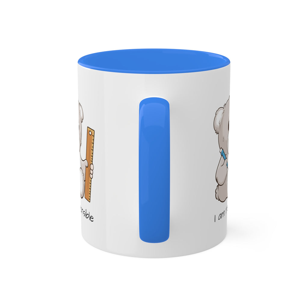 A white mug with a cambridge blue handle and interior and a picture of a bear that says I am responsible.