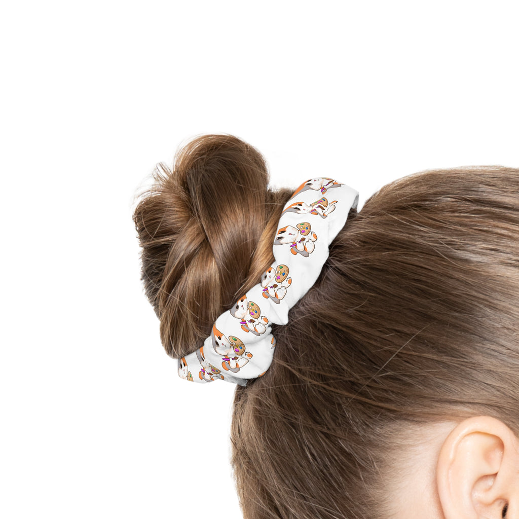 Side-view of a female wearing a white hair scrunchie with a repeating pattern of a cat around her hair.
