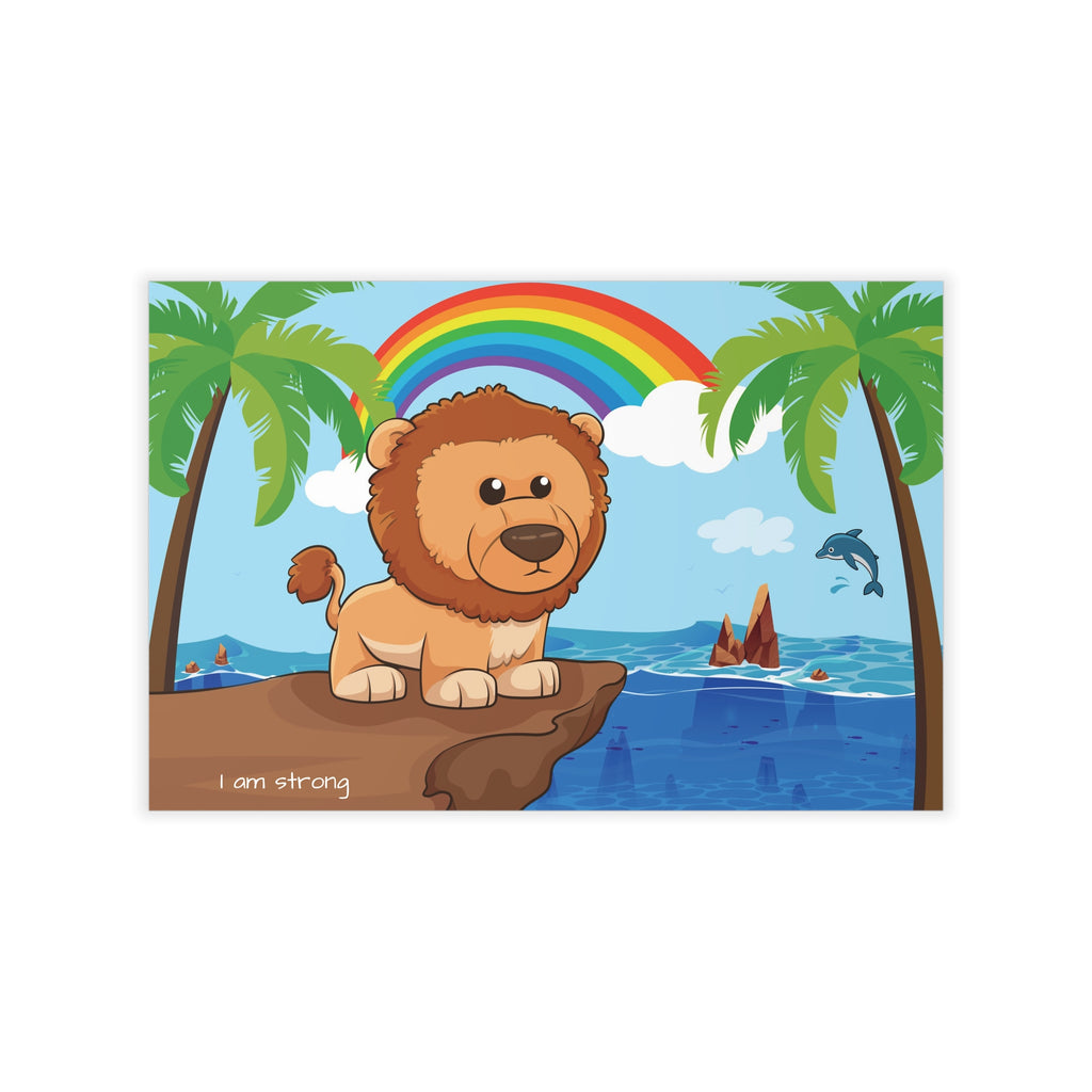 A wall decal that has a scene of a lion standing on a cliff over the ocean, a rainbow in the background, and the phrase "I am strong" along the bottom.