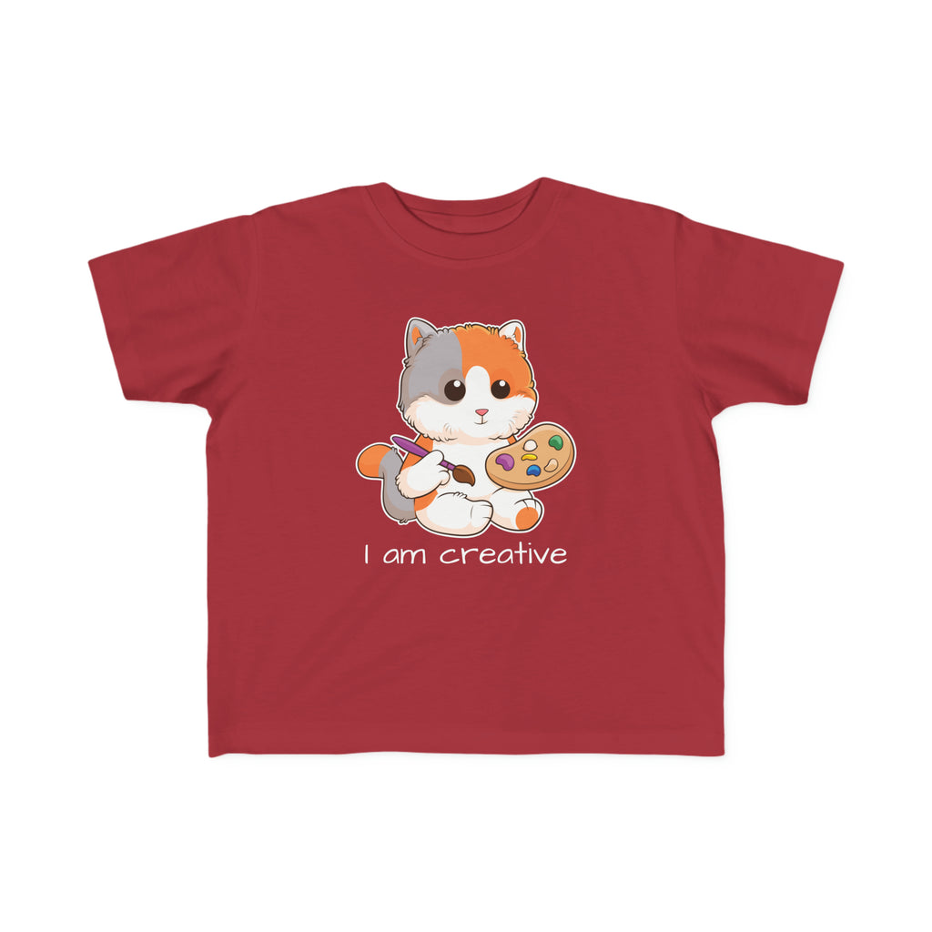 A short-sleeve garnet red shirt with a picture of a cat that says I am creative.
