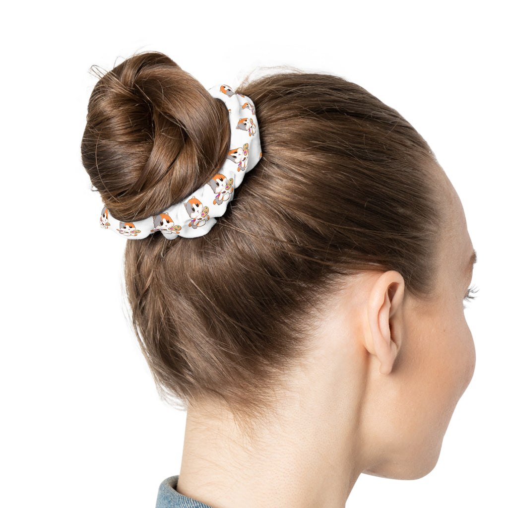 Back-view of a female wearing a white hair scrunchie with a repeating pattern of a cat around her hair.
