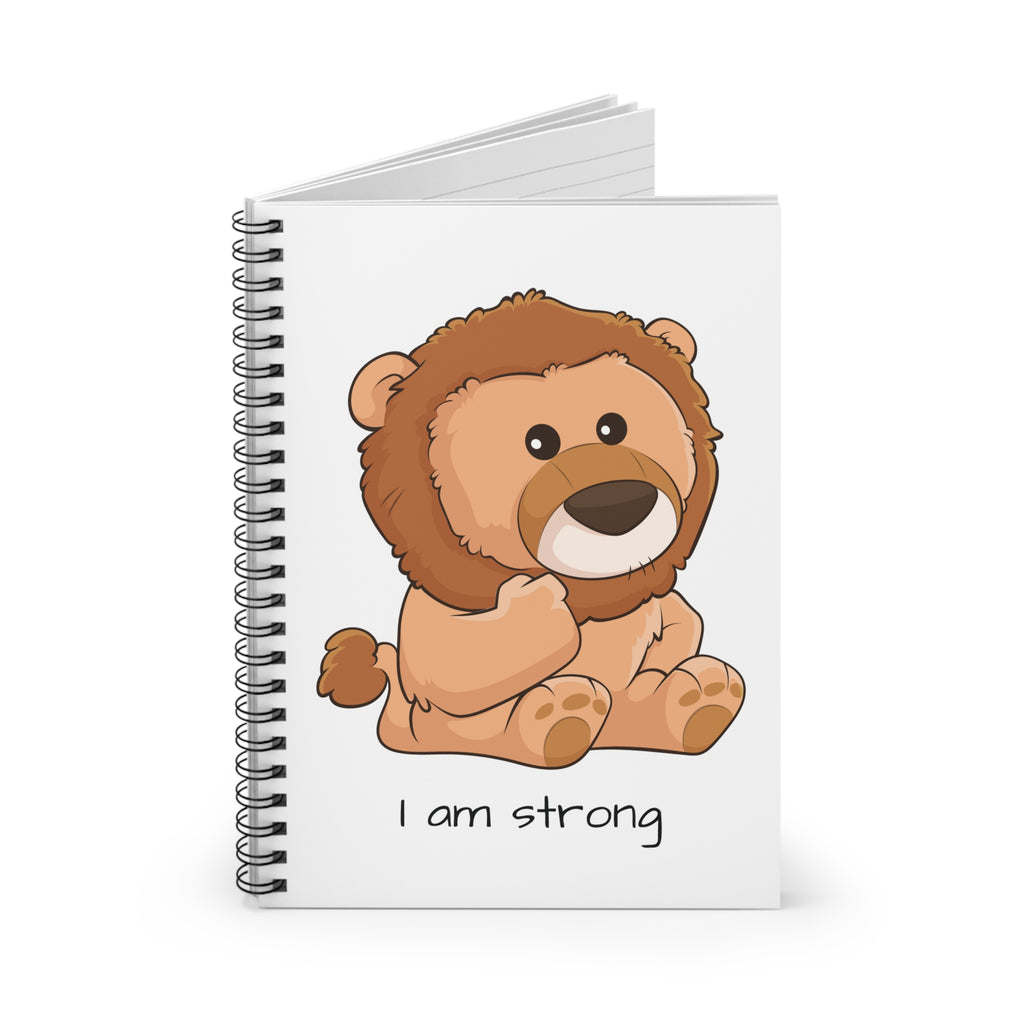 White spiral notebook standing up, featuring a picture of a lion that says I am strong on the front.