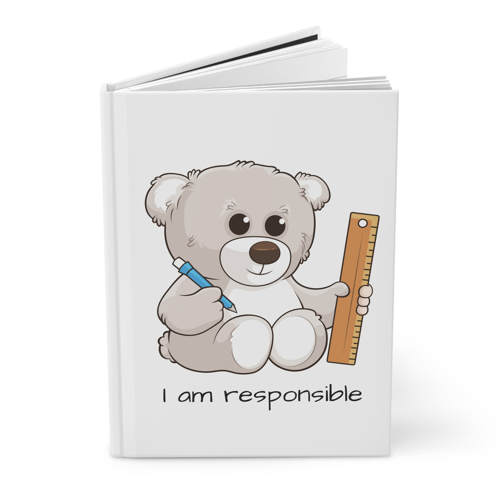 White hardcover journal standing up, featuring a picture of a bear that says I am responsible on the front.