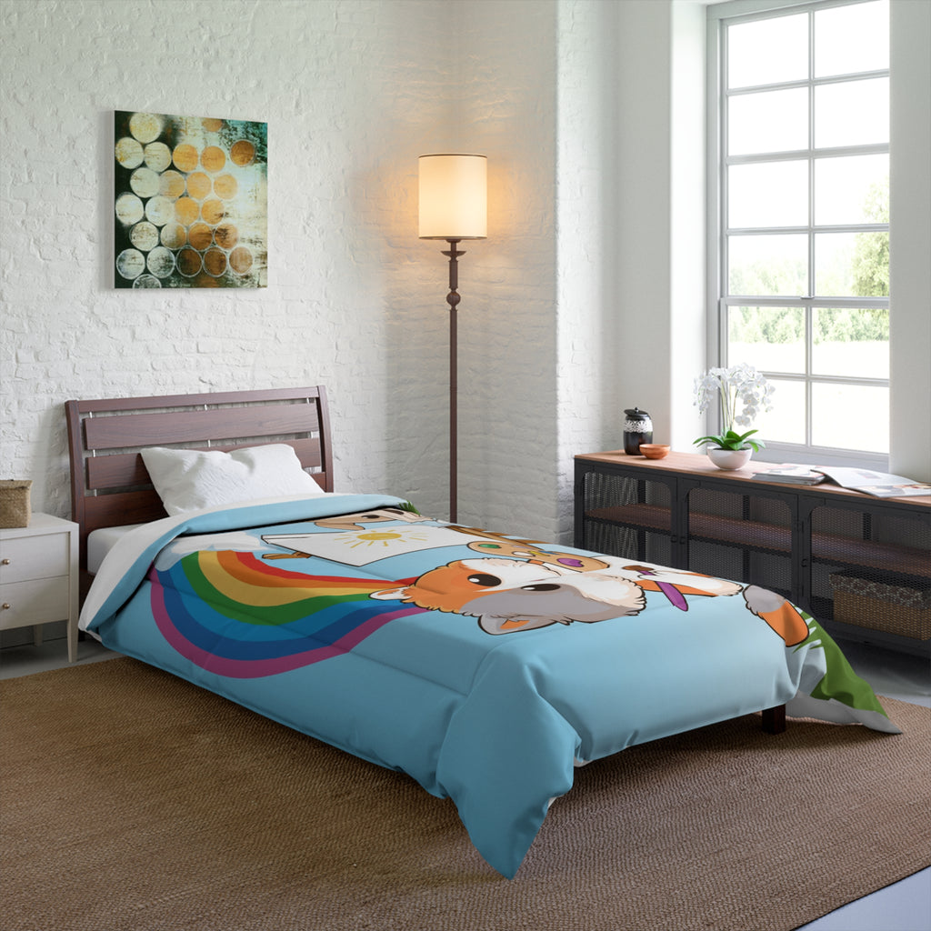 A 68 by 92 inch bed comforter with a scene of a cat painting on a canvas next to a dog, a rainbow in the background, and the phrase "I am creative" along the bottom. The comforter covers a twin extra long sized bed.