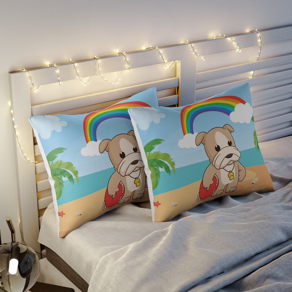 Two pillows sitting on a bed. The pillows have on pillowcases with a scene of a dog lifeguard standing on the beach, a rainbow in the background, and the phrase "I am loyal" along the bottom.