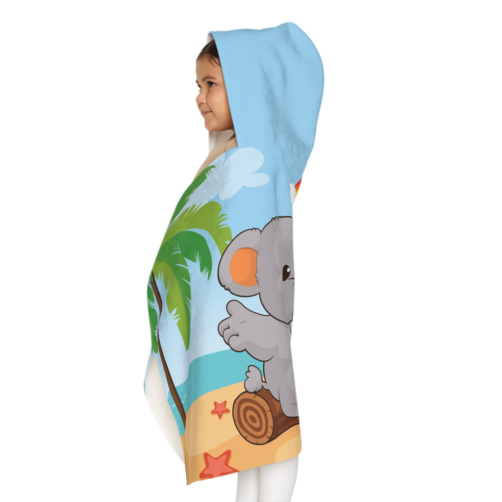 Left side-view of a girl wearing a hooded towel and holding it closed around her. The towel has a scene of an elephant having a bonfire with a bird and fish on the beach, a rainbow in the background, and the phrase "I am calm" along the bottom.
