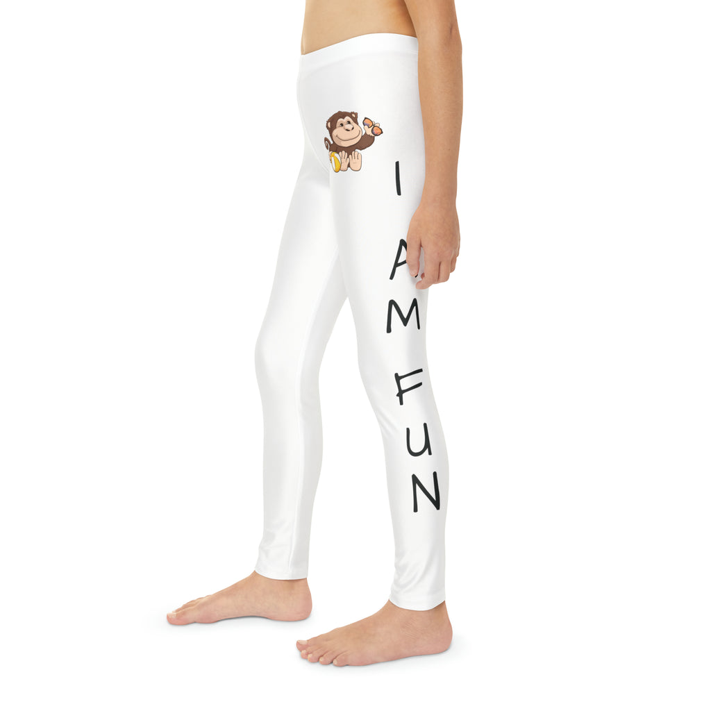 Left side-view of a child wearing white leggings with a picture of a monkey on the front left waist and the phrase "I am fun" read top to bottom on the side of each leg.