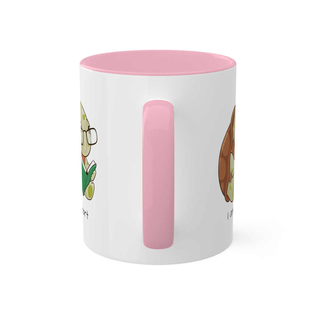 A white mug with a pink handle and interior and a picture of a turtle that says I am smart.