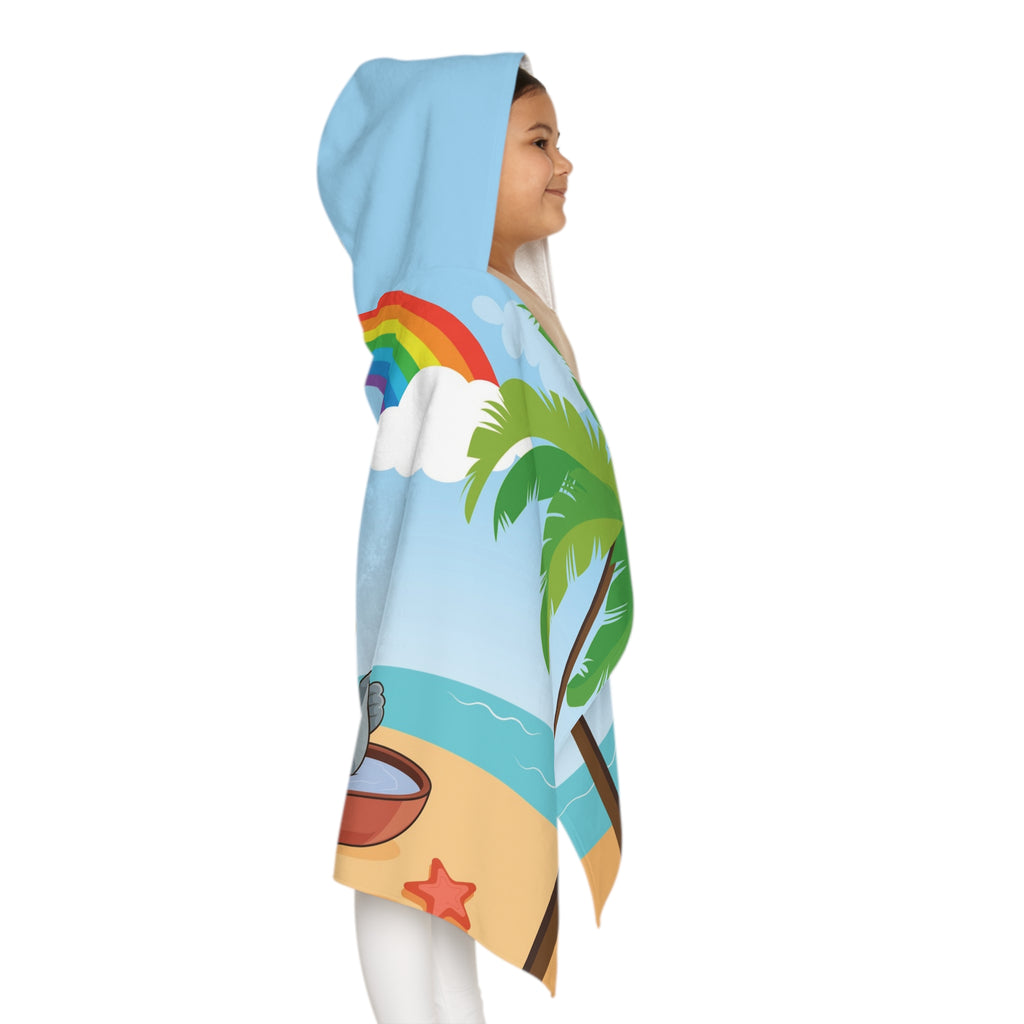 Right side-view of a girl wearing a hooded towel and holding it closed around her. The towel has a scene of an elephant having a bonfire with a bird and fish on the beach, a rainbow in the background, and the phrase "I am calm" along the bottom.