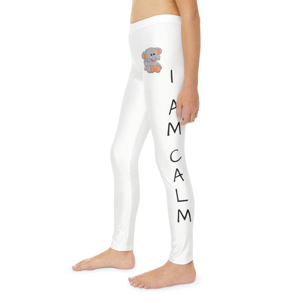 Left side-view of a child wearing white leggings with a picture of an elephant on the front left waist and the phrase "I am calm" read top to bottom on the side of each leg.