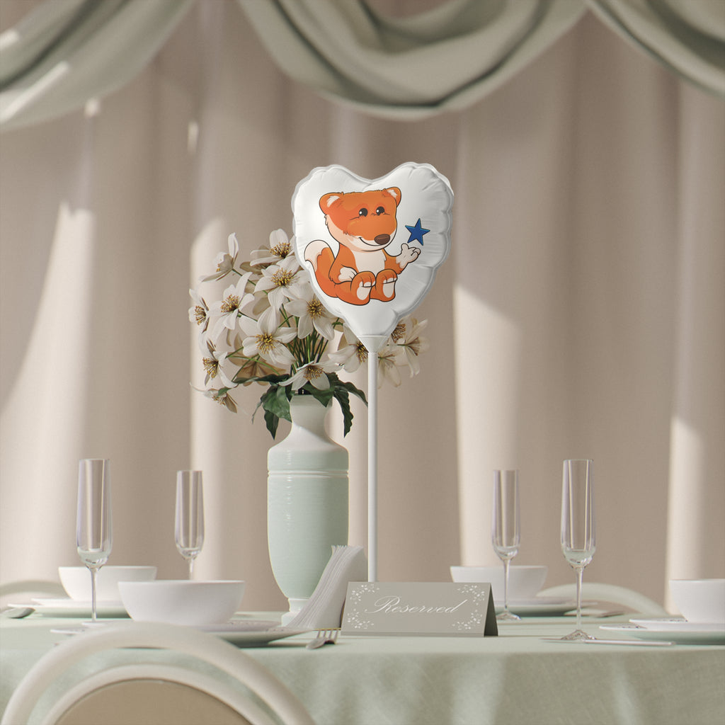 A heart-shaped white mylar balloon on a stick with a picture of a fox. The balloon sits on a table decorated for an event.