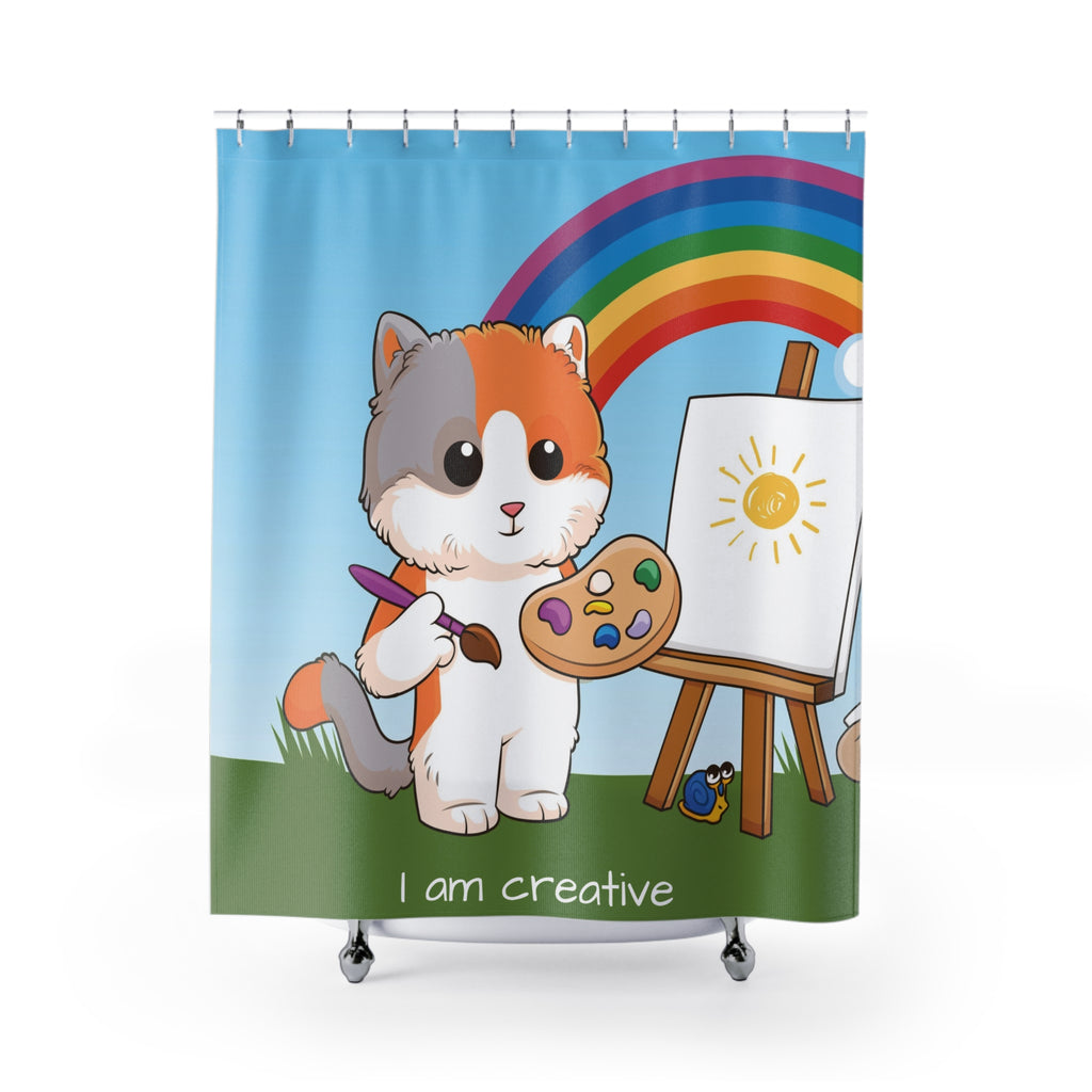 A shower curtain hanging from a rod in front of a stand-alone tub. The shower curtain has a scene of a cat painting on a canvas with a rainbow in the background and the phrase "I am creative" along the bottom.