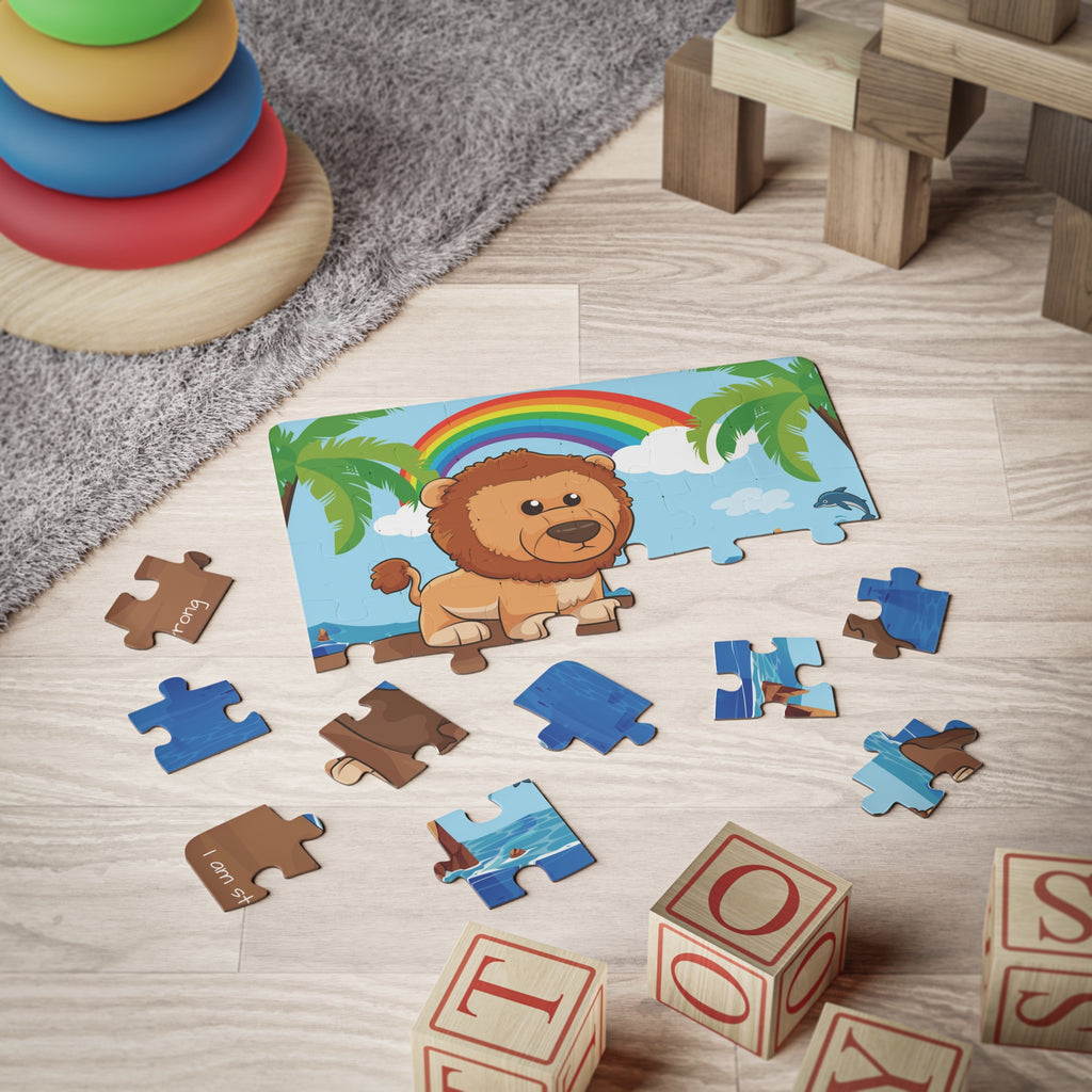 A 30 piece puzzle with a scene of a lion standing on a cliff over the ocean, a rainbow in the background, and the phrase "I am strong" along the bottom. The puzzle is partially assembled on the floor of a child's playroom.
