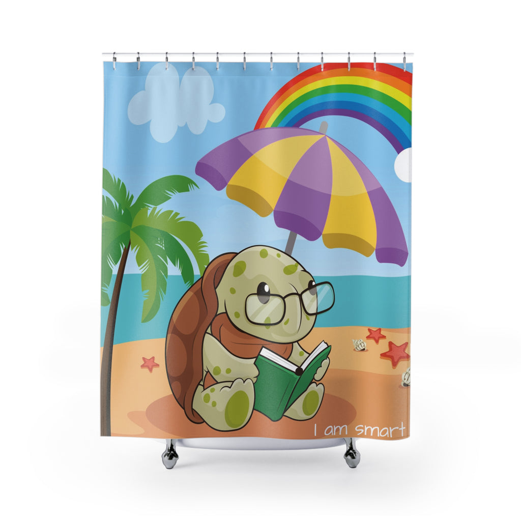 A shower curtain hanging from a rod in front of a stand-alone tub. The shower curtain has a scene of a turtle reading a book under an umbrella on a beach with a rainbow in the background and the phrase "I am smart" along the bottom.