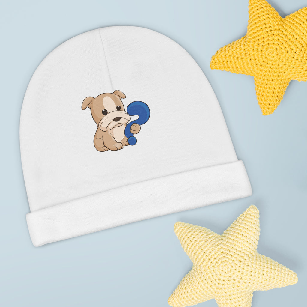 A white baby beanie with a small picture of a dog. The beanie has the bottom edge folded up.