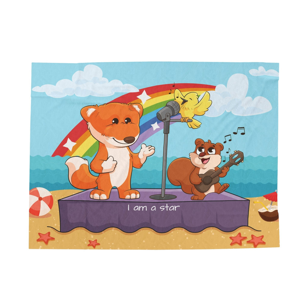 A blanket that has a scene of a fox singing with a bird and squirrel on a stage on the beach, a rainbow in the background, and the phrase "I am a star" along the bottom.