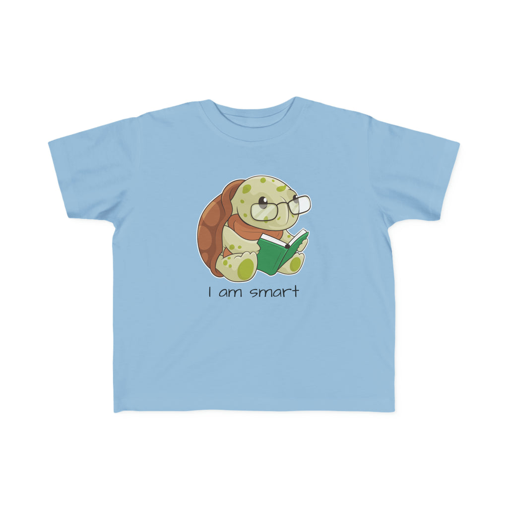 A short-sleeve light blue shirt with a picture of a turtle that says I am smart.