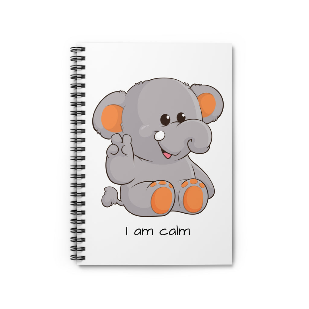 White spiral notebook laying closed, featuring a picture of an elephant that says I am calm.