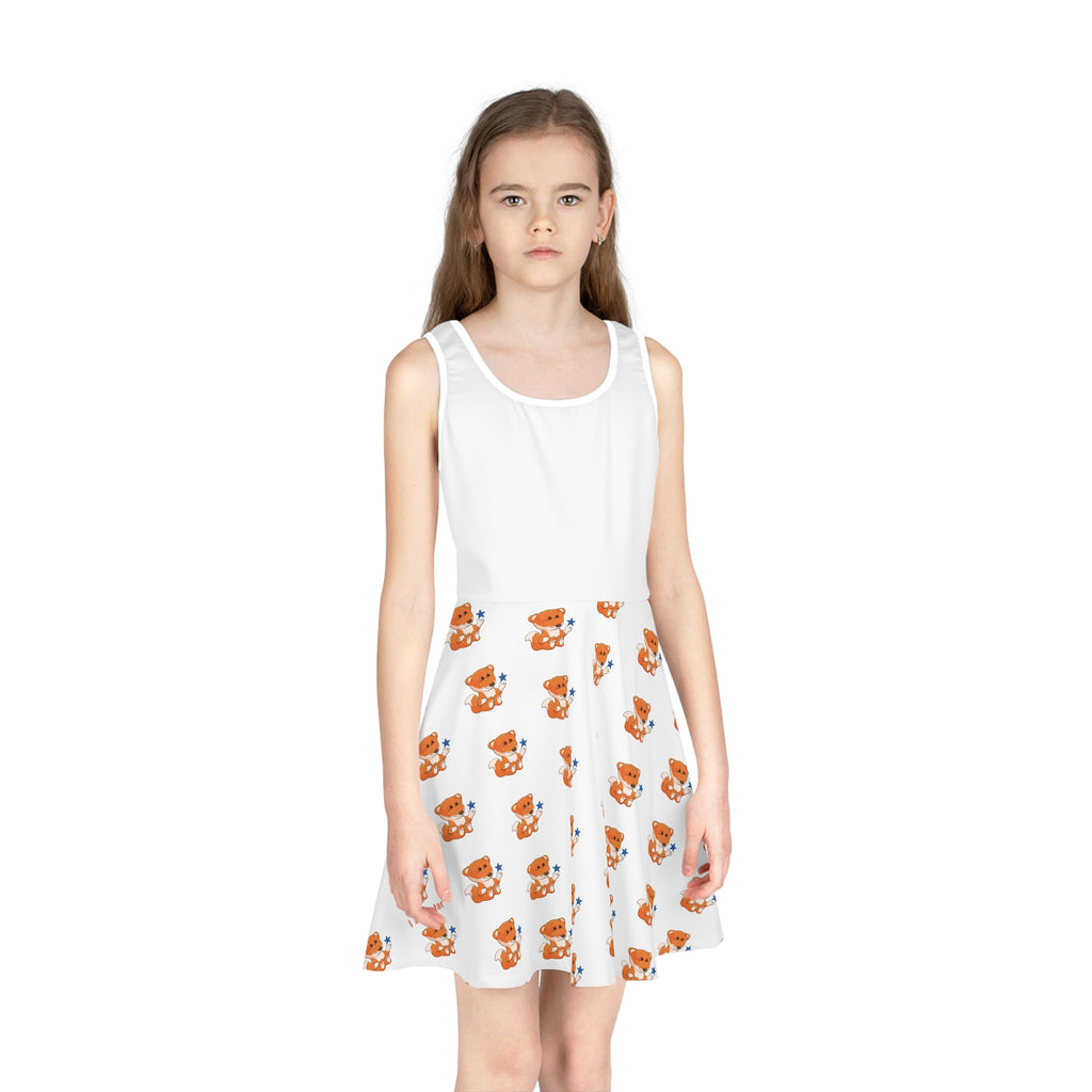 Front-view of a girl wearing a sleeveless white dress with a white top and a repeating pattern of a fox on the skirt.