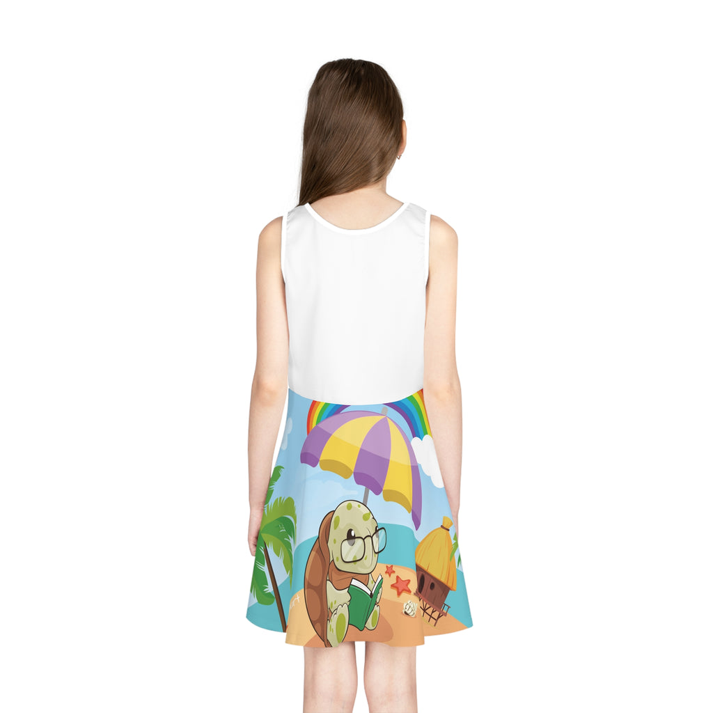 Back-view of a girl wearing a sleeveless dress. The dress has a white top and the skirt features a scene of a turtle reading a book under an umbrella on the beach and the phrase "I am smart".